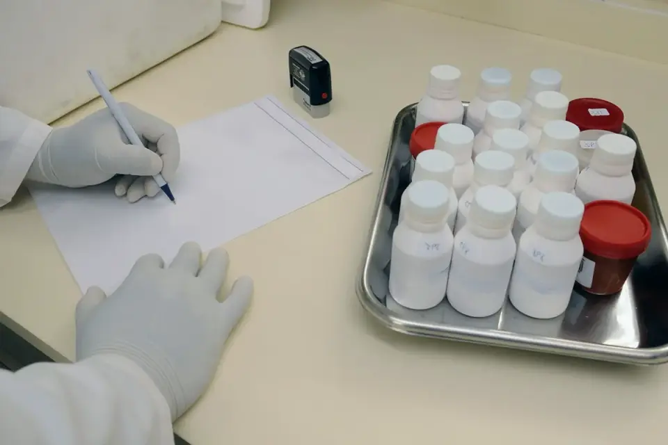 A lab technician analyzing supplement samples at a bench