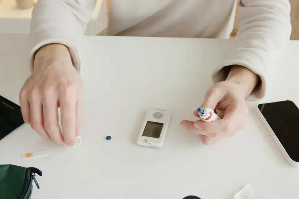 A veterinarian checking a dog&#x27;s blood glucose level in an exam room